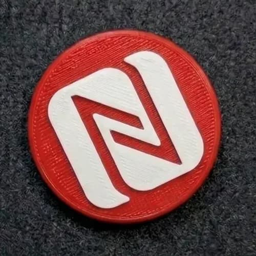 Red 3D-printed Tapora NFC badge with a white NFC logo