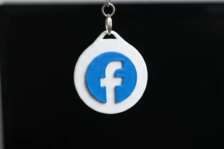 White custom Tapora NFC keychain printed with a Facebook logo - design yours with your own logo