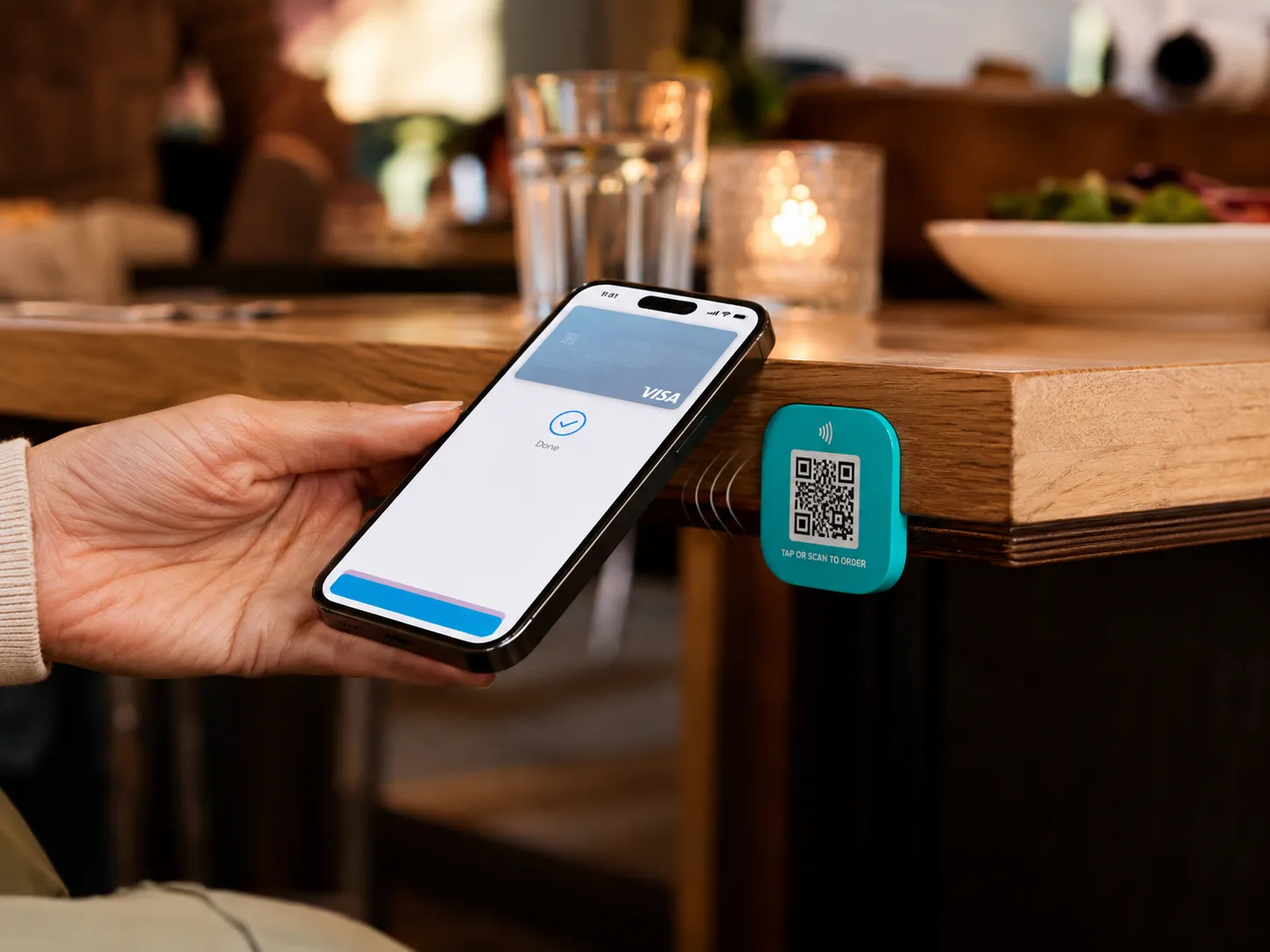 Customer tapping NFC badge at restaurant table to leave a Google Review
